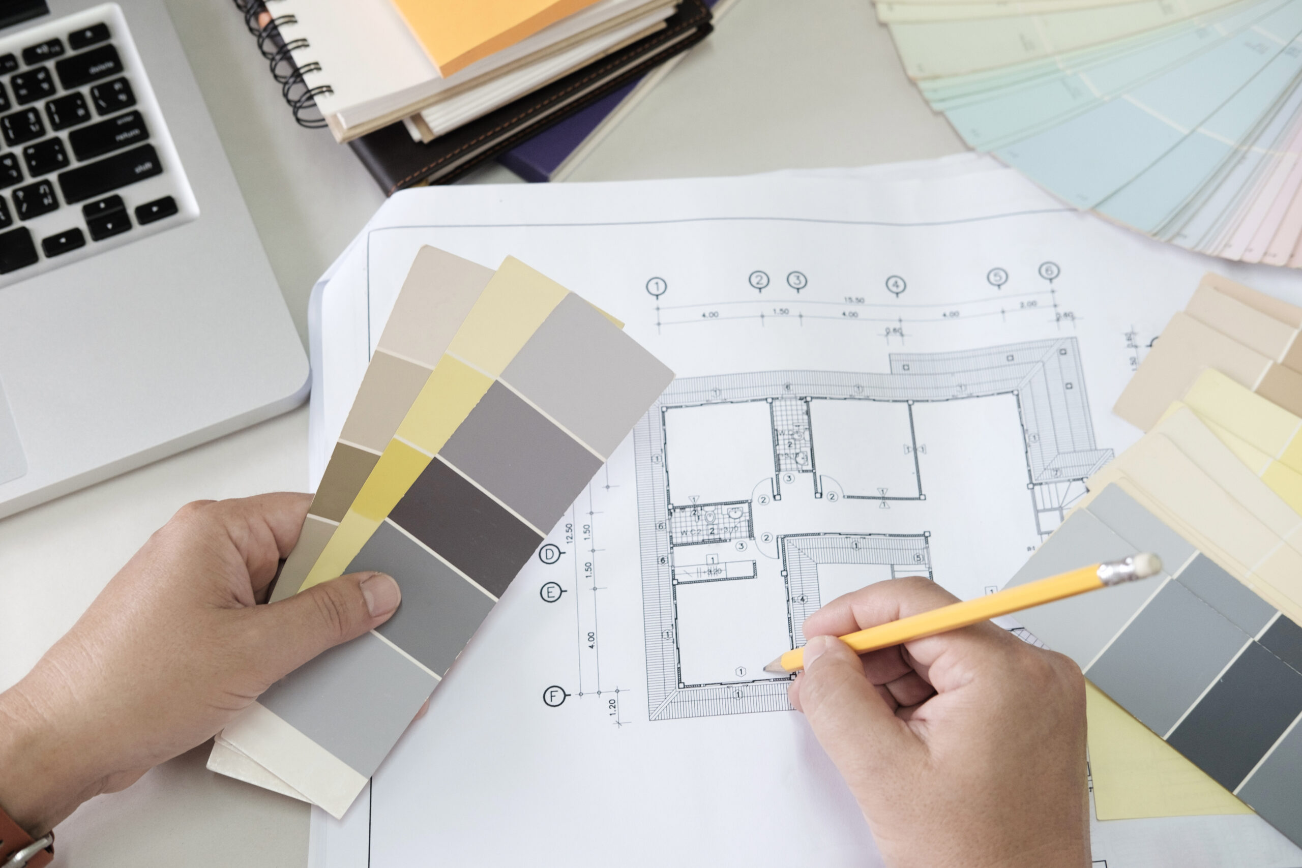 Graphic design and color swatches and pens on a desk. Architectu Graphic design and color swatches and pens on a desk. Architectural drawing with work tools and accessories.